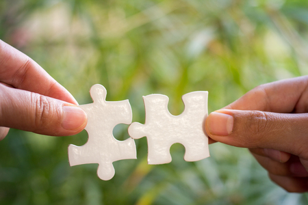 Businessman hands connecting jigsaw puzzle. Business solutions, success and strategy, learning...
