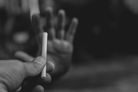 No Smoking, female showing stop sign with hand to cigarettes. Quit smoking concept. World no tobacco day.の写真素材