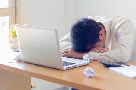Stressed businessman having problems and headache.の写真素材