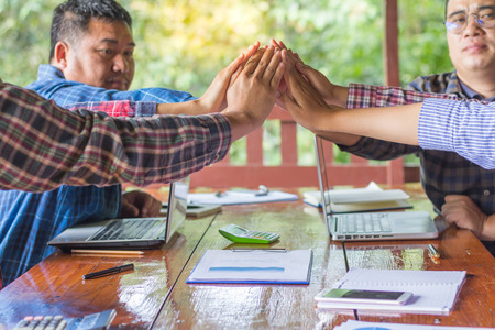young business people putting their hands together. Stack of hands. Unity and teamwork concept.