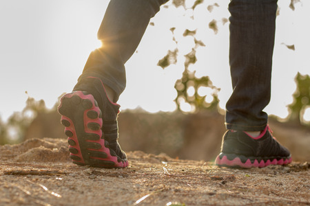 Female legs walking. Female hikers travel nature mountain map navigationの写真素材