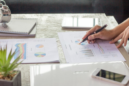 Businessman pen pointing graph chart for analyzing investment,Business analysis and strategy concept,の写真素材
