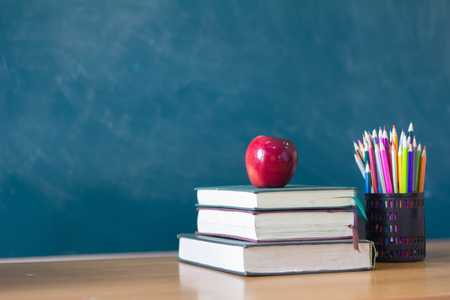 Apple puts on a book studying ,The background is blackboard, educational conceptsの写真素材