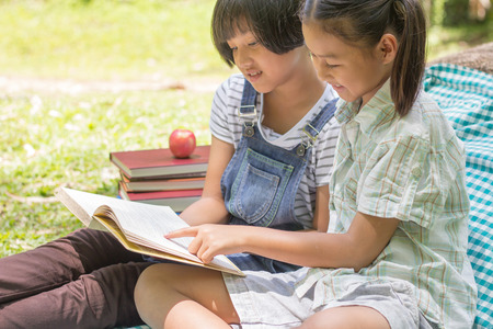 Two children are studying the book, educational and Scientific Conceptsの写真素材