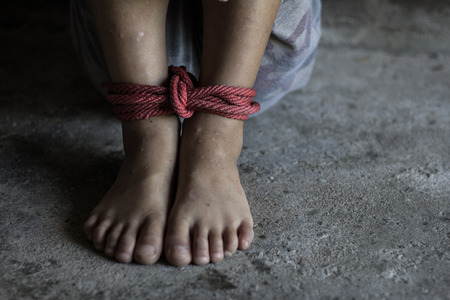 Kidnapped boy tied with rope. stop abusing violence.concept for kidnapping, violence, terrified,  Human Rightsの写真素材