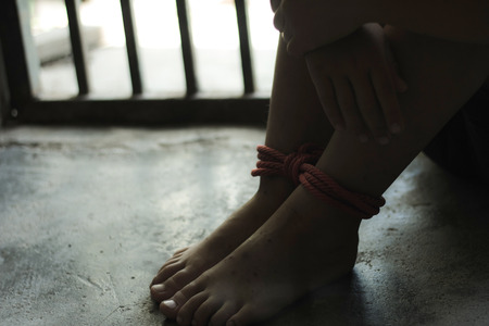 Kidnapped boy tied with rope and locked in a steel cage. stop abusing violence.concept for kidnapping, violence, terrified,  Human Rightsの写真素材