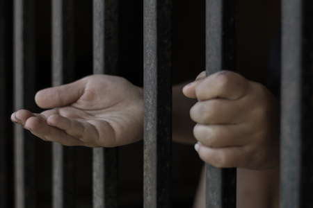 The child in the iron cage extended his hand,The concept of helping children from traffickingの写真素材
