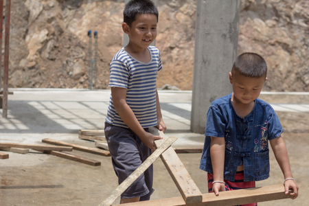 Two children were forced to work on construction because of poverty. Violence children and trafficking concept,Anti-child labor, Rights Day on December 10.の写真素材