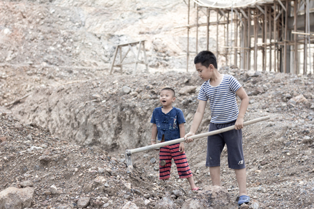 Children are forced to dig, work because of poverty. Violence children and trafficking concept,Anti-child labor, Rights Day on December 10.の写真素材