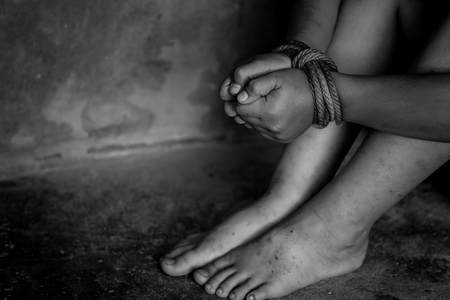 Kidnapped boy tied with rope. stop abusing violence.concept for kidnapping, violence, terrified, A fearful child, Human Rights, Violence against children, International Anti-Trafficking Dayの写真素材