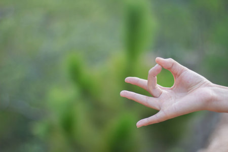 Close up of woman hand, meditating on yoga practice.の写真素材