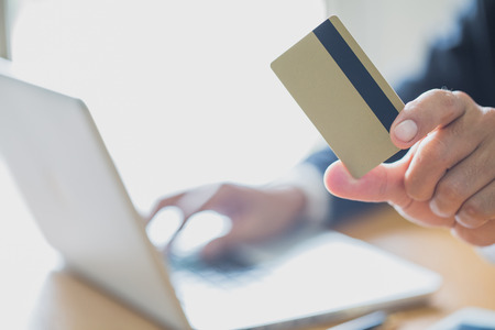 Businessmen holding credit cards print details online shopping, Hands holding credit card and using...