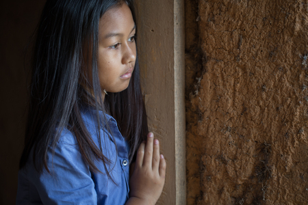 Portrait of a poor little thailand girl lost in deep thoughts, poverty, Poor childrenの写真素材