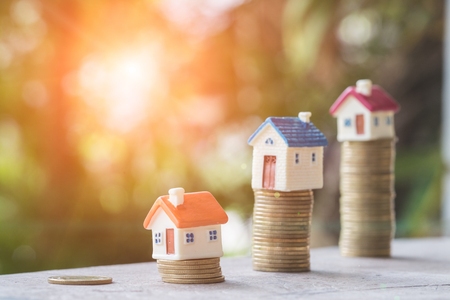 Mini house on stack of coins,Money and house, Real estate investment, Save money with stack coin, Mortgage concept.の写真素材