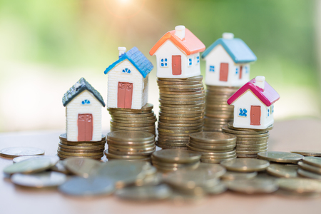 Mini house on stack of coins, Real estate investment, Save money with stack coin, Business growth investment and financial, Mortgage concept.の写真素材