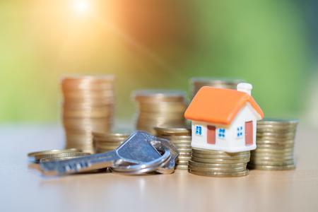 Mini house on stack of coins,Money and house, Real estate investment, Save money with stack coin, Mortgage concept.の写真素材