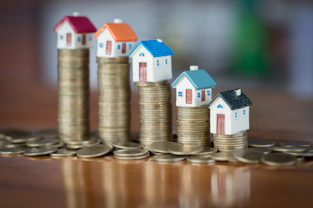 Mini house on stack of coins, Real estate investment, Save money with stack coin, Business growth investment and financial, Mortgage concept.の写真素材