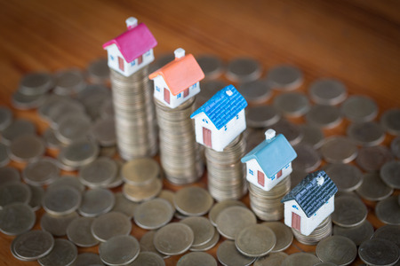 Mini house on stack of coins, Real estate investment, Save money with stack coin, Business growth investment and financial, Mortgage concept.の写真素材