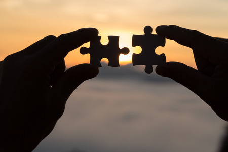 Silhouette Woman hands connecting couple puzzle piece against sunrise, Business solutions, target,...