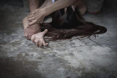 Close up of man hands holding a woman hands for rape and sexual abuse.の写真素材