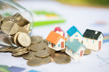 Mini house on stack of coins,Money and house, Real estate investment, Save money with stack coin, Mortgage concept.の写真素材