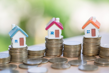 Mini house on stack of coins,Money and house, Real estate investment, Save money with stack coin, Mortgage concept.の写真素材