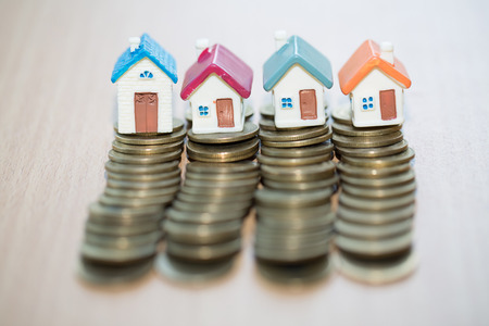Mini house on stack of coins,Money and house, Real estate investment, Save money with stack coin, Mortgage concept.の写真素材