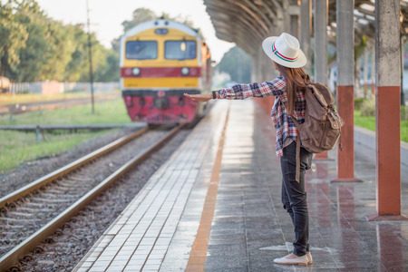 Beautiful young asian woman waiting for train at train station, Travel and vacation concept.  Chinese tourists.の写真素材