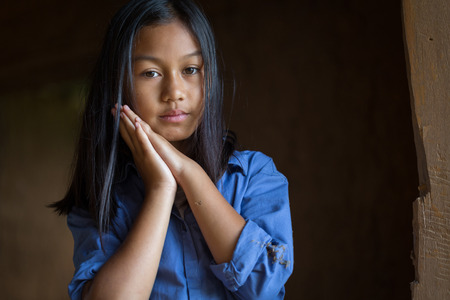 Portrait of a poor little thailand girl lost in deep thoughts, poverty, Poor children, War refugeesの写真素材