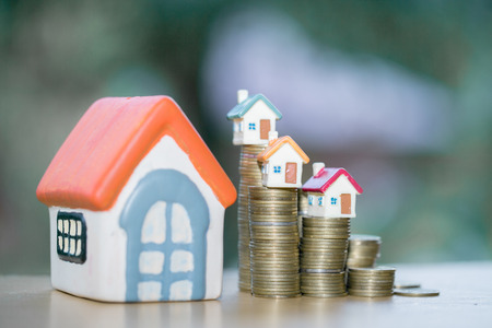 House model on top of stack of money as growth of mortgage credit, Concept of property management. Invesment and Risk Management.の写真素材