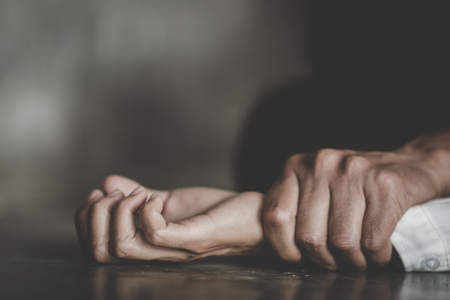 Man's hand holding a woman hand for rape and  abuse concept.の写真素材