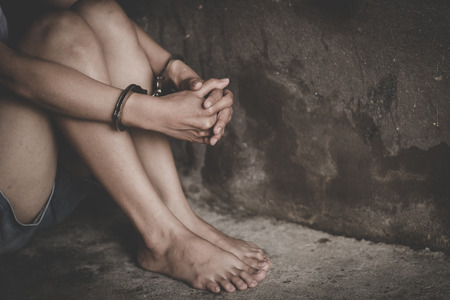 The slave girl was handcuffed and kept. Women violence and abused concept, Imprisonment, Female prisoner,  human trafficking Concept, international women's day.の写真素材