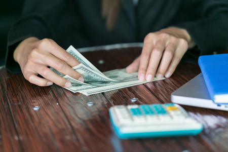 business woman with money in hand, Hands counting us dollar bills.の写真素材