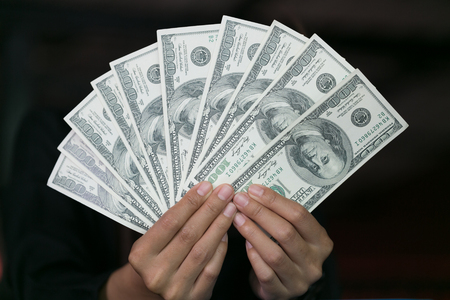 business woman with money in hand, Hands counting us dollar bills.の写真素材