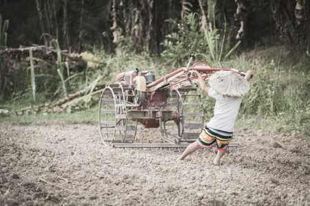 Child labor, Poor children driving a plow farming area, Children have to work because of poverty, World Day Against Child Labour concept.の写真素材