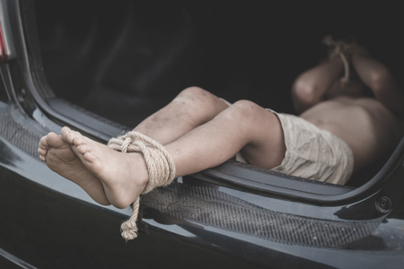 Little boy with rope tied legs and hands in car, children thief, Criminal stealing child in human child traficking concept,の写真素材