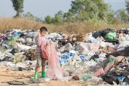 Children find junk for sale and recycle them in landfills, the lives and lifestyles of the poor, Child labor, Poverty and Environment Conceptsの写真素材