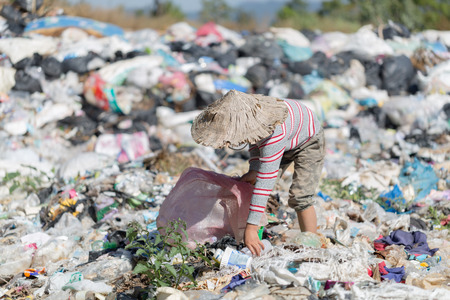 Children find junk for sale and recycle them in landfills, the lives and lifestyles of the poor, Child labor, Poverty and Environment Conceptsの写真素材