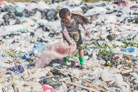 Children find junk for sale and recycle them in landfills, the lives and lifestyles of the poor, Child labor, Poverty and Environment Conceptsの写真素材