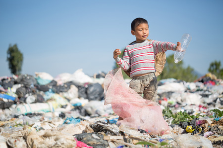 Children find junk for sale and recycle them in landfills, the lives and lifestyles of the poor, Poverty and Environment Conceptsの写真素材