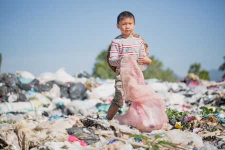 Children find junk for sale and recycle them in landfills, the lives and lifestyles of the poor, Child labor, Poverty and Environment Conceptsの写真素材
