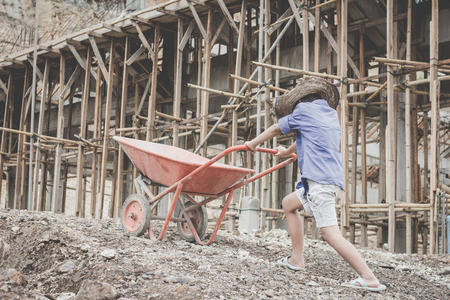 Poor children work in construction sites because of poverty, Child labor, human trafficking, World Day Against Child Labour concept.の写真素材