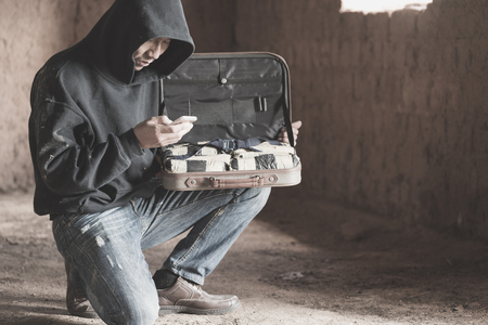 Drug dealers use the phone to contact the customer, drug trafficking, crime, addiction and sale, The concept of buying and selling drugs.の写真素材