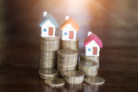 Mini house on stack of coins,Money and house, Real estate investment, Save money with stack coin, Mortgage concept.の写真素材