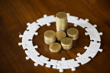 House model on stack coins.Jigsaw puzzle, Saving money and property Management concept.の写真素材