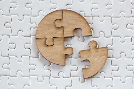 4 Four brown pieces of puzzle on a white jigsaw background, last piece of jigsaw puzzle to complete the mission, Business solutions, success and strategy conceptの写真素材