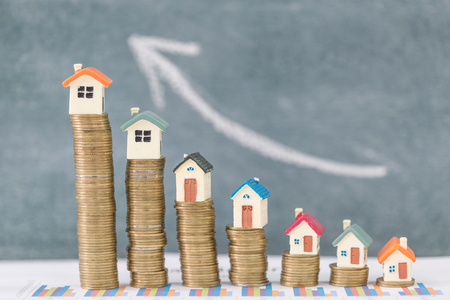 Mini house on stack of coins,Money and house, Real estate investment, Save money with stack coin, Mortgage concept, Real estate growth.の写真素材