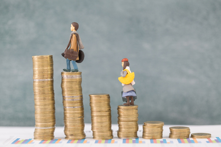 Miniature business people stand on pile of money coin, Travel saving and planing concept.の写真素材