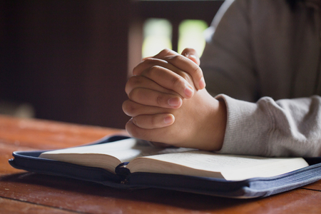 woman hands praying to god with the bible.  begging for forgiveness and believe in goodness. Christian life crisis prayer to god.の写真素材
