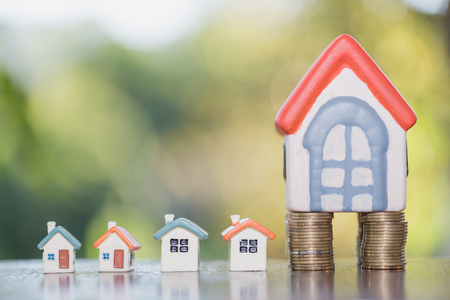 House model on top of stack of money as growth of mortgage credit, Concept of property management. Invesment and Risk Management.の写真素材